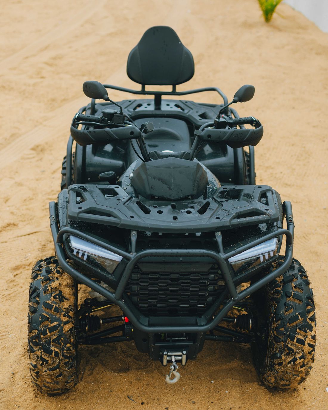 A quad bike on the open sand