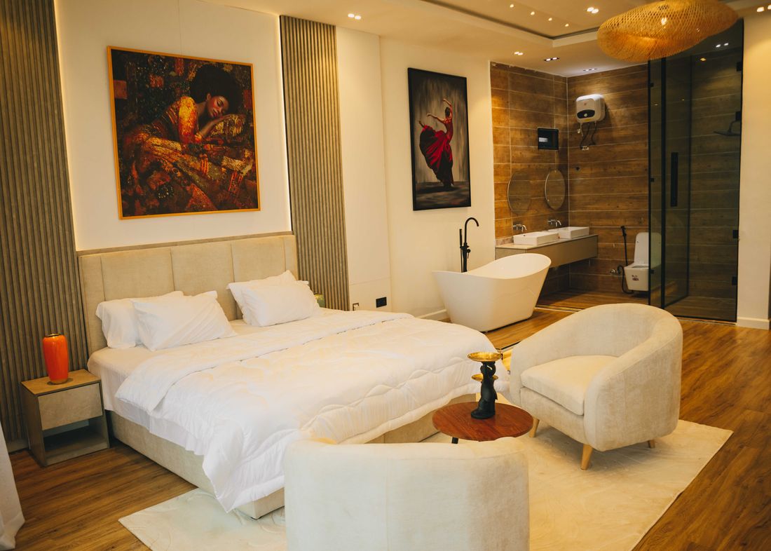 A bedroom with a freestanding bath at the foot of the bed
