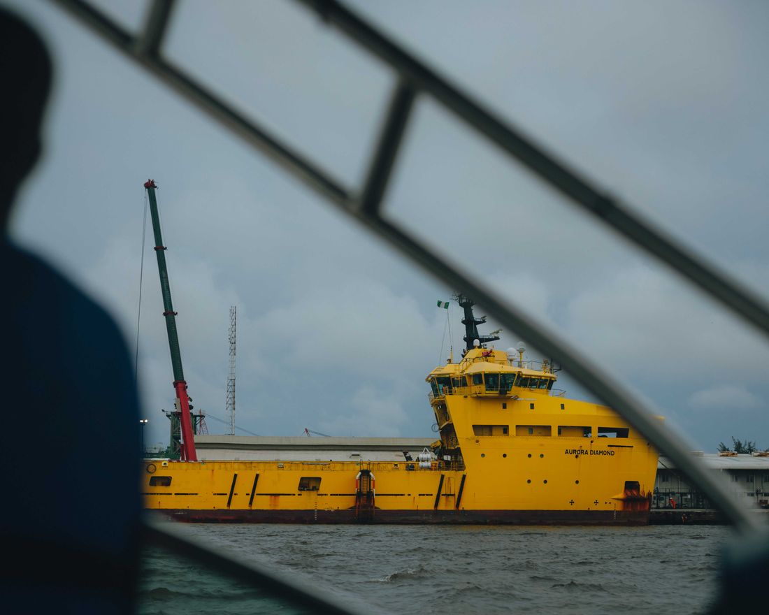 A supply vessel on the water, seen from the boat rail during the crossing